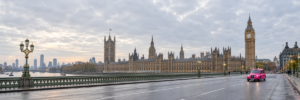 Pink London taxi on Westminster Bridge with the Houses of Parliament in the background